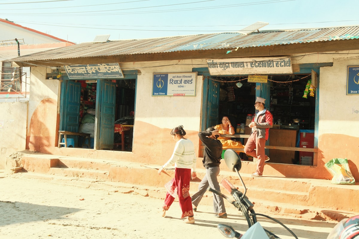 Customers passing a small local shop